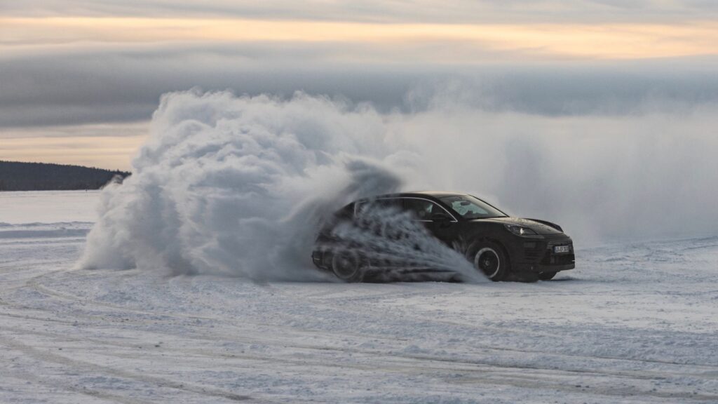 Porsche EV Macan driving through snow